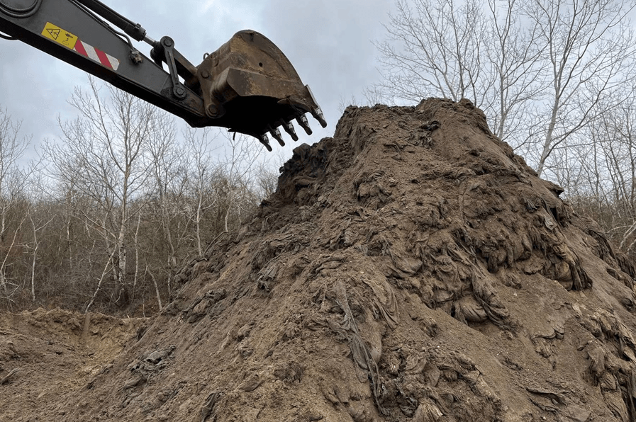 The sand and fuel oil mixture being dumped at a 'temporary storage site' near the village of Voskresensky.