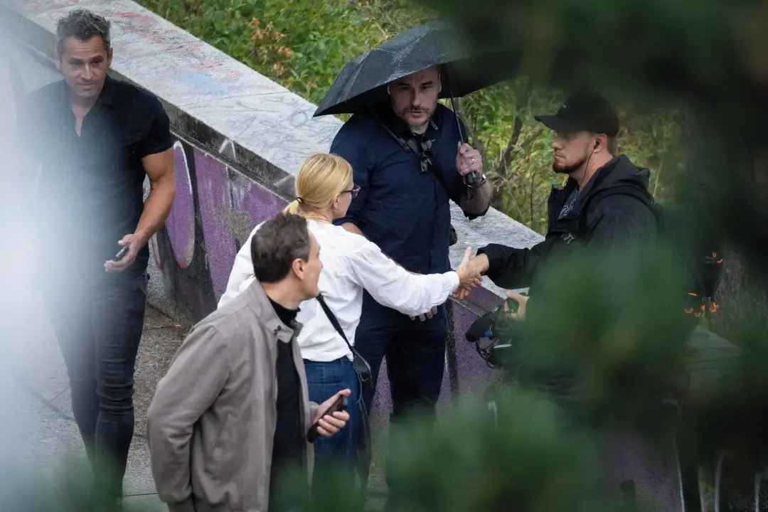Vitaly, in a gray jacket, and Igor, right, shortly before they ran from Seznam Zprávy journalists after being confronted with questions. At left is Bohumil Kartous, whom they had tried to interview. Photo: Renata Matějková / Seznam Zprávy