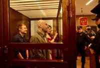Left to right: journalists Konstantin Gabov, Sergey Karelin, and Antonina Favorskaya during sentencing on April 15. Artyom Kriger is seen behind them.