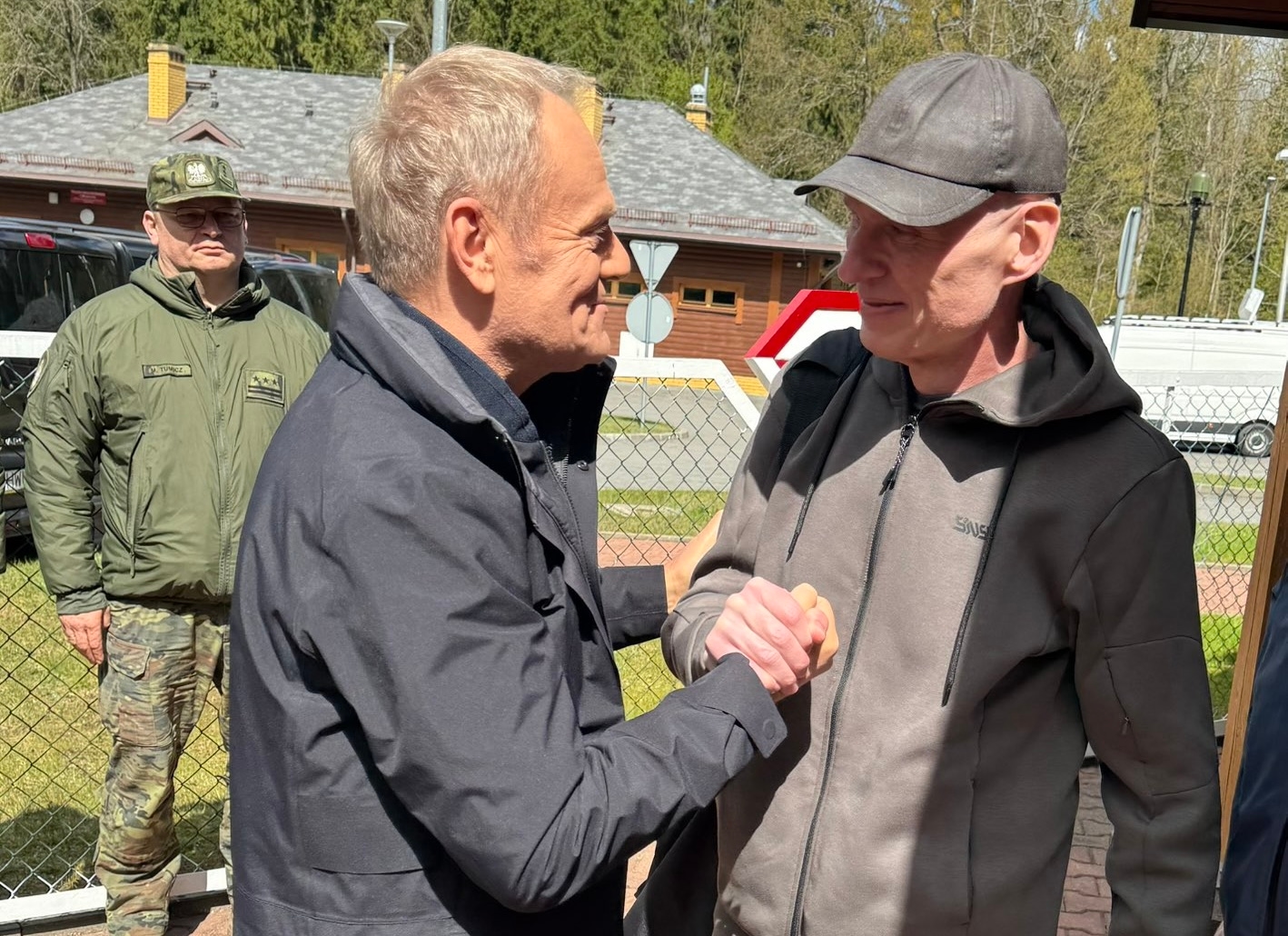 Donald Tusk greeting journalist Andrzej Poczobut at the Polish border after his release from a Belarusian prison on April 28, 2026
