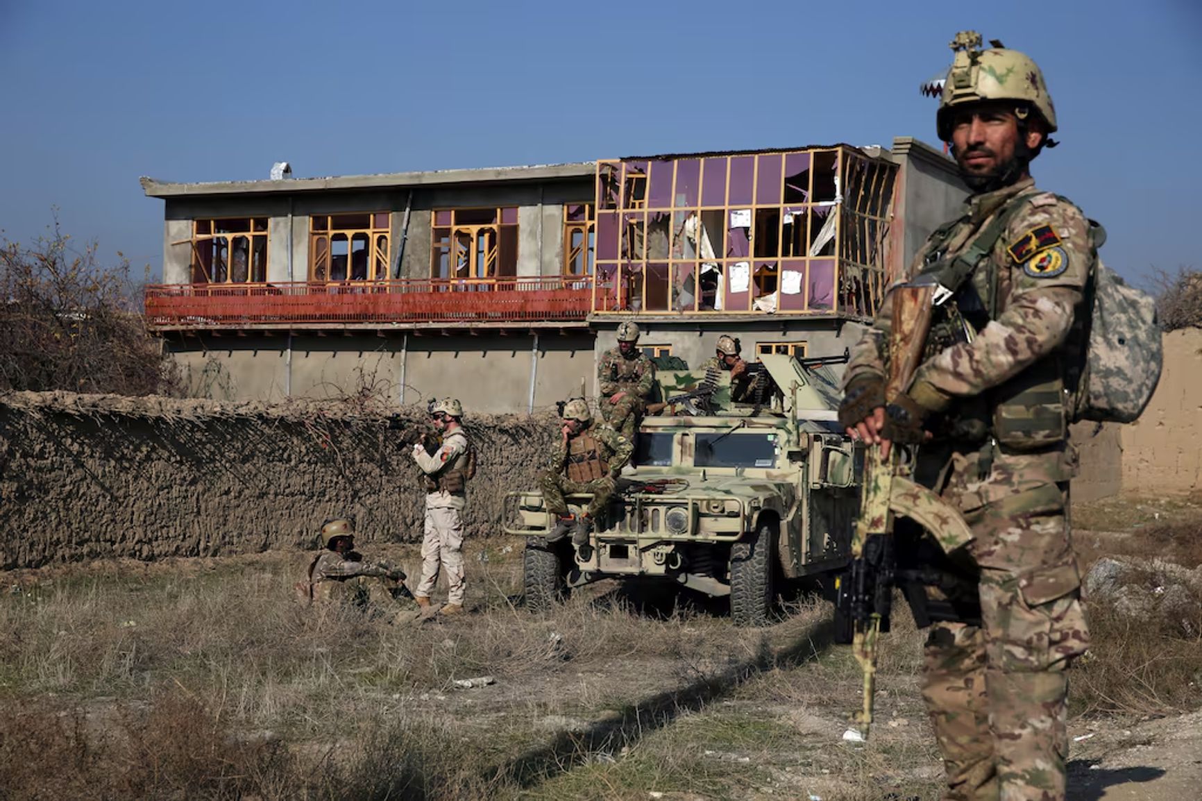 Security forces stand watch near the scene of an attack close to Bagram Airbase in Parwan province, Kabul, Afghanistan, on Wednesday, Dec. 11, 2019.