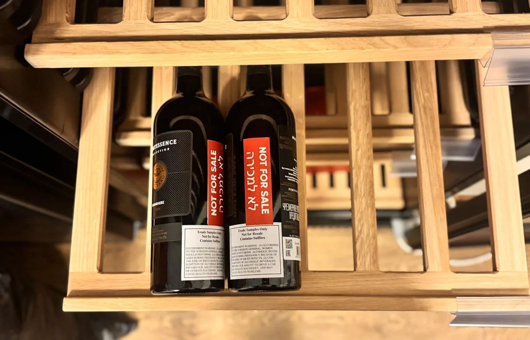 Examples of bottles with stickers in Hebrew reading “Not for sale” 