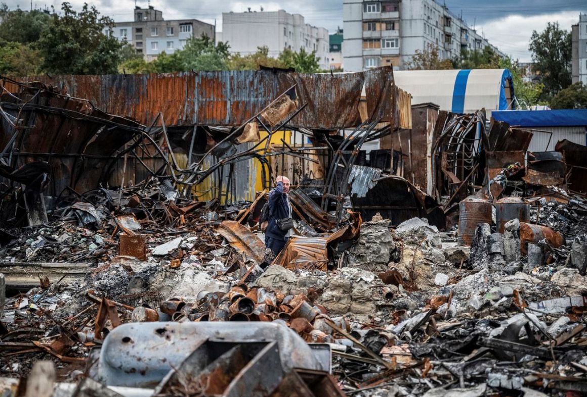A resident of Kharkiv among the ruins of a street market destroyed by Russian missile strikes in September 2022.