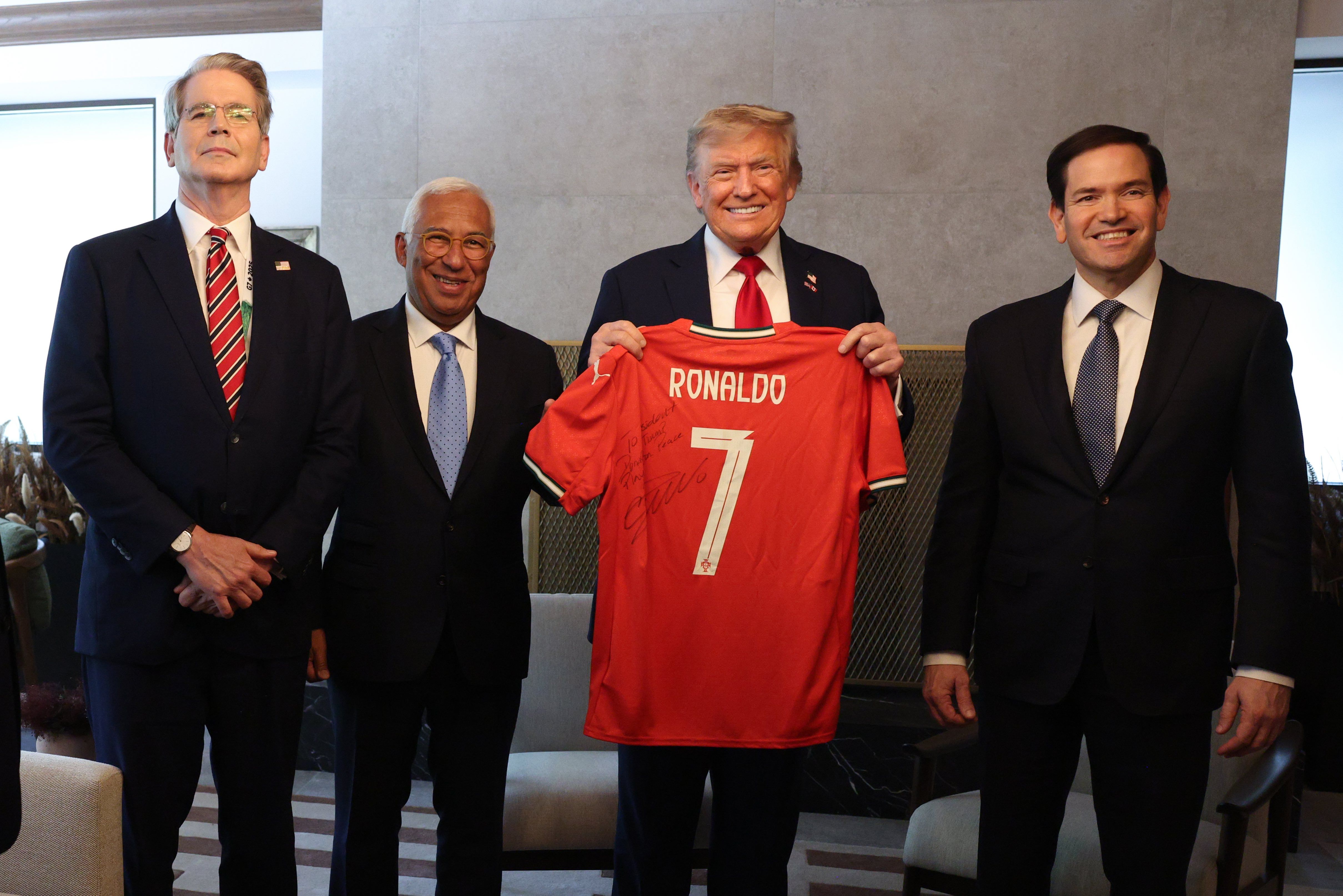European Council President António Costa presents Donald Trump with a Cristiano Ronaldo jersey at the G7 summit on June 17, 2025