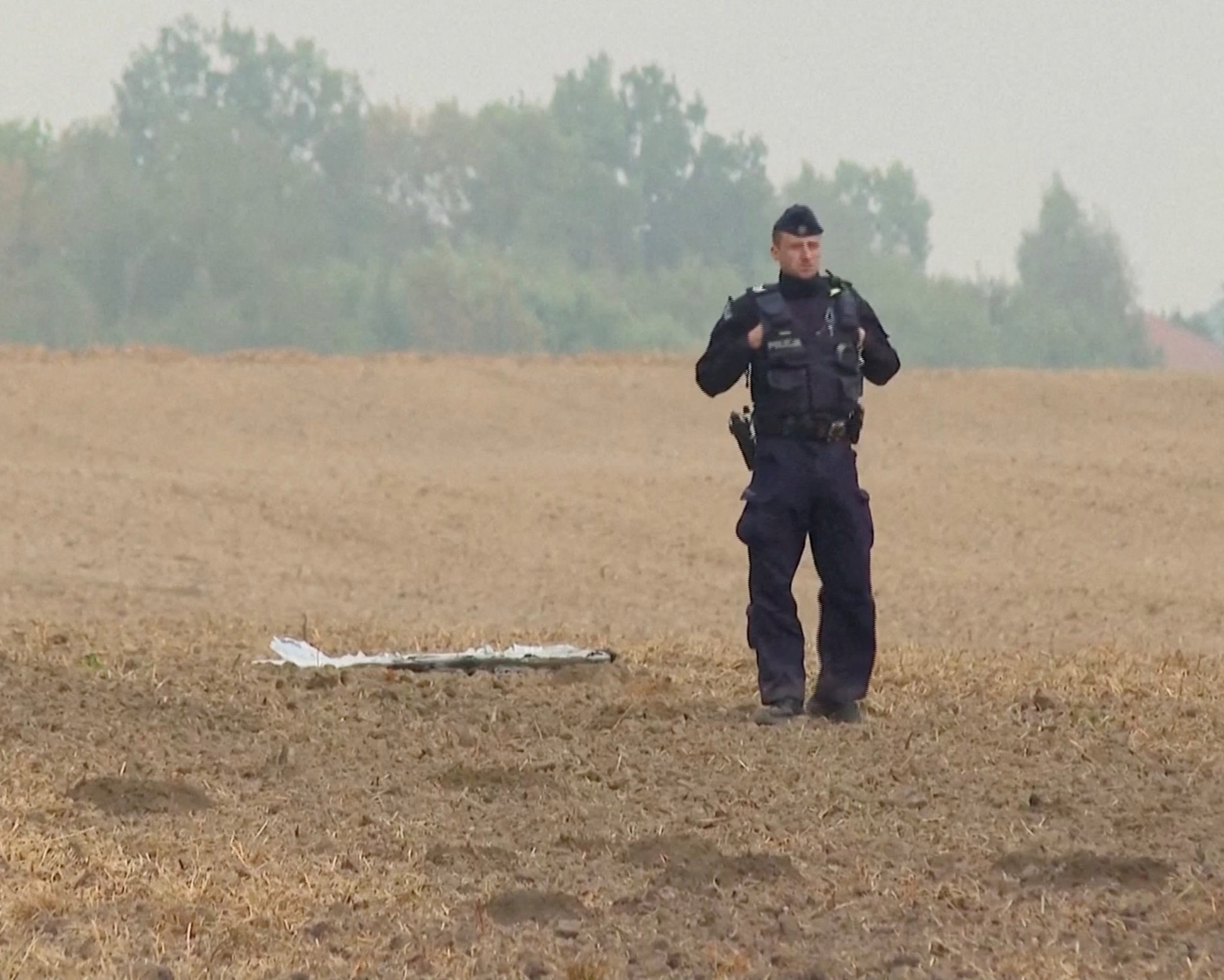 A Polish police officer guards the debris of a Russian drone after the overnight attack on Sept. 10. Photo: Polsat News / Reuters
