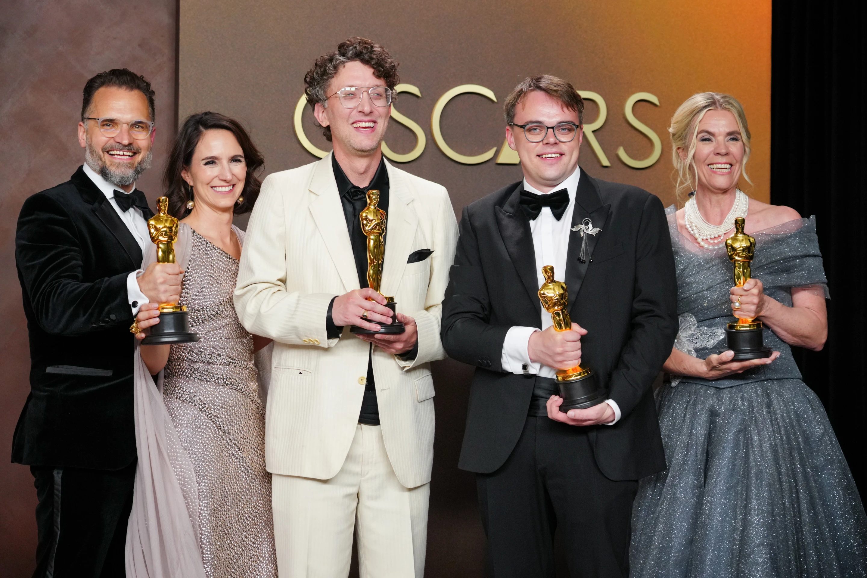 Pavel Talankin (second from right) and David Borenstein (center) at the Oscars. Photo: AP